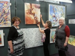 Sylvia Hawthorne (centre) who has been hanging entries for 30 years, gives some tips to Helen Pain and Judith Crowley (right) 